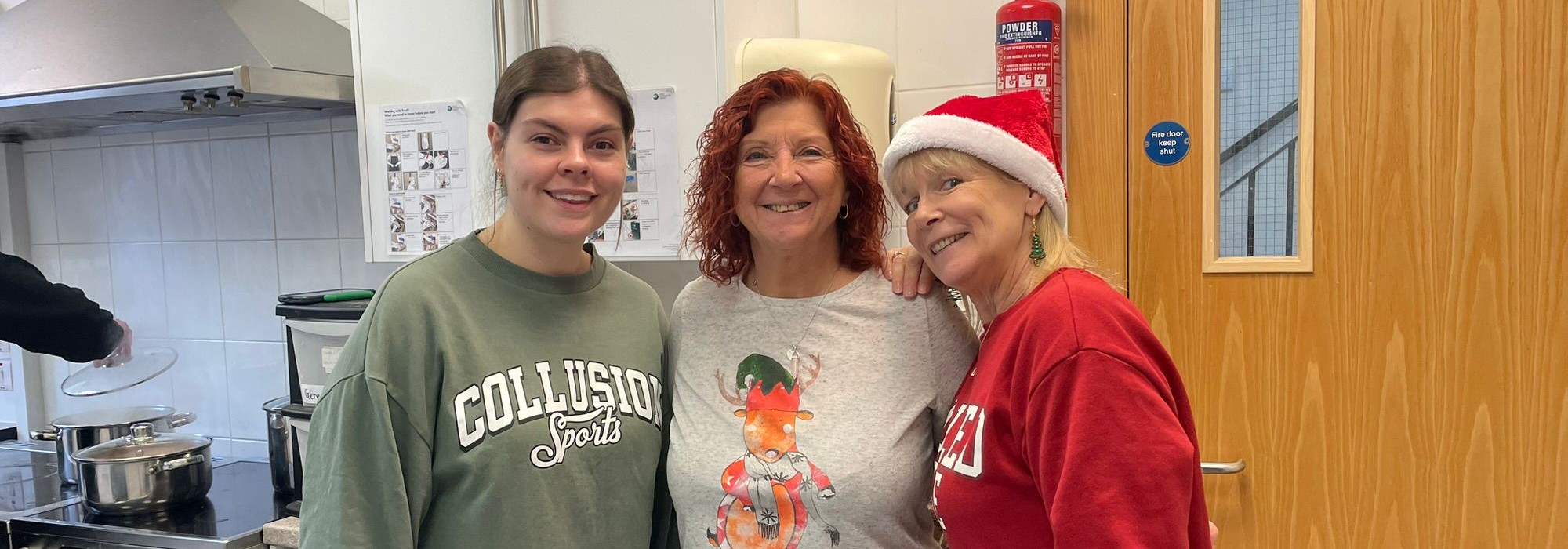 Community volunteers posing in the kitchen